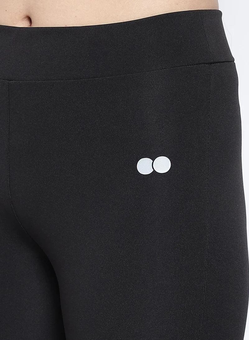 Clovia Black Snug Fit Active Tights in Black with Reflective Logo for Women | Best Price UAE
